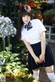 A woman in a school uniform posing for a picture.